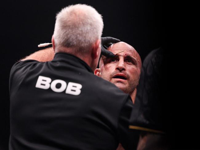 Australia's Alexander Volkanovski has blood wiped off his body during his Lightweight bout against Russia's Islam Makhachev in the Ultimate Fighting Championship 294 (UFC) event at the Etihad Arena in Abu Dhabi on October 22, 2023. (Photo by Giuseppe CACACE / AFP)