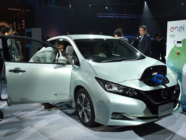 Japan's Nissan Motor displays the company's new Nissan LEAF, the next evolution of the zero-emission electric vehicle, during the world premiere in Makuhari, Chiba prefecture on September 6, 2017.  Japanese giant Nissan on September 6 unveiled a new electric car with an extended range and semi-autonomous driving functions, as it seeks to battle off competitors in a sector it once pioneered. / AFP PHOTO / KAZUHIRO NOGI