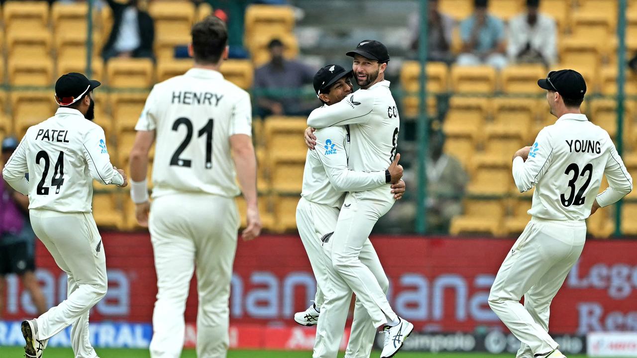 New Zealand's players celebrate after the dismissal of India's Sarfaraz Khan. Photo by IDREES MOHAMMED / AFP.