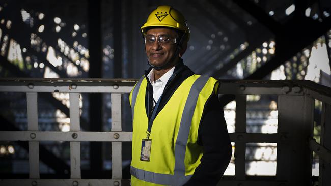 Waruna Kaluarachchi, Sydney Harbour Bridge Works Manager, walks under wiring which controls electrical signs and lighting on the Sydney Harbour Bridge. Photos: Chris McKeen