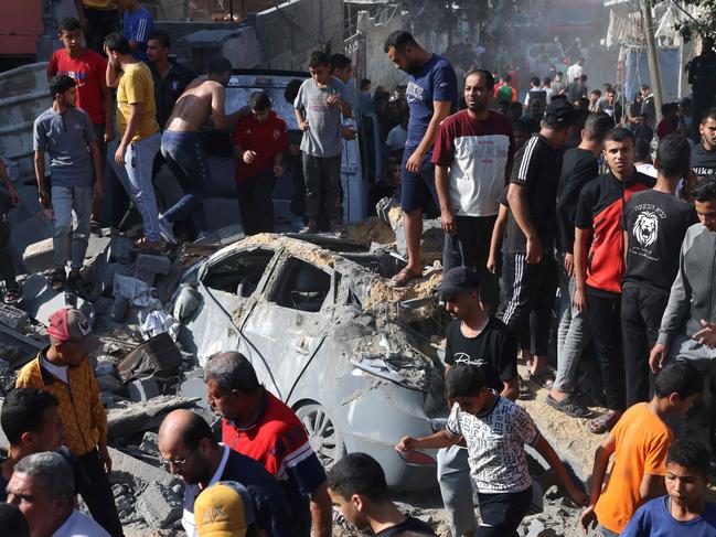 Palestinians looks for victims from under a collapsed home following an Israeli air strike in Rafah, in the southern Gaza Strip. Picture: AFP