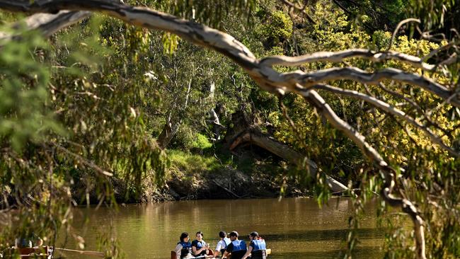 Tourists take advantage of the winter sun as they row a boat up Melbourne's Yarra River on August 19, 2024. (Photo by William WEST / AFP)