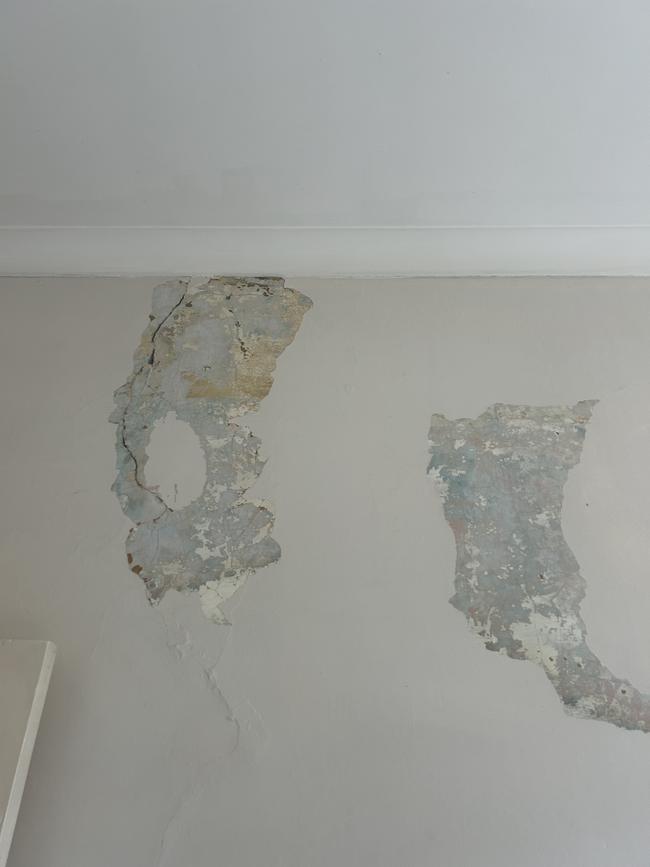 Walls in the living room covered in cracks and water damage. Picture: Mikaela Wilkes