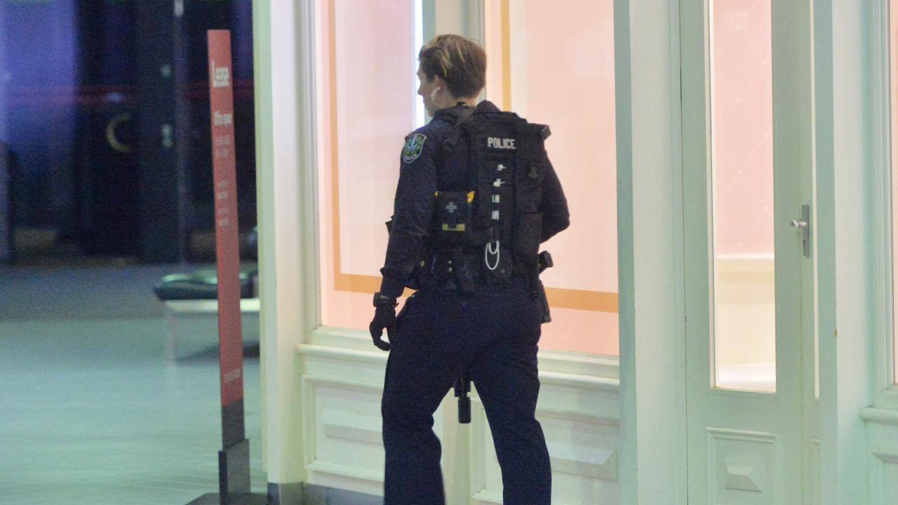 A STAR Group officer checks through the Westfield Marion where armed youths were reported inside. Picture: NewsWire / Brenton Edwards