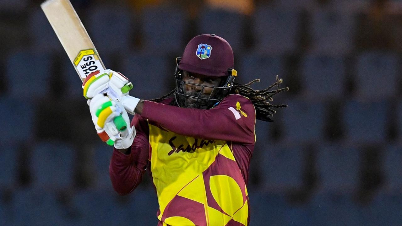 Chris Gayle of West Indies hits 4 during the 3rd T20I between Australia and West Indies at Darren Sammy Cricket Ground, Gros Islet, Saint Lucia, on July 12, 2021. (Photo by Randy Brooks / AFP)