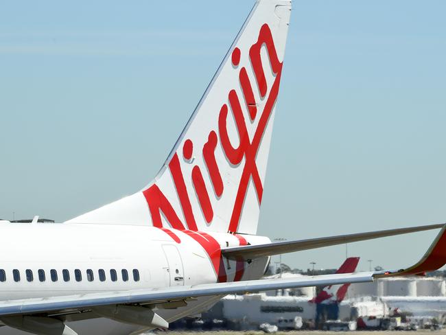 Virgin Australia aircraft a Sydney Airport in Sydney, Thursday, March 19, 2020. Qantas has suspended all international flights and will stand down two-thirds of its 30,000-strong workforce until the end of May. (AAP Image/Joel Carrett) NO ARCHIVING