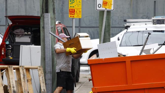 A man cleaning up outside a business in Milton. Picture: Tertius Pickard