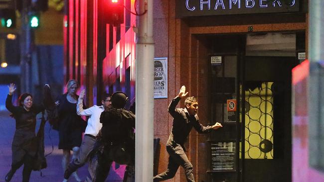 Hostages run from the Lindt Cafe during the December 2014 siege. Picture: Joosep Martinson/Getty Images