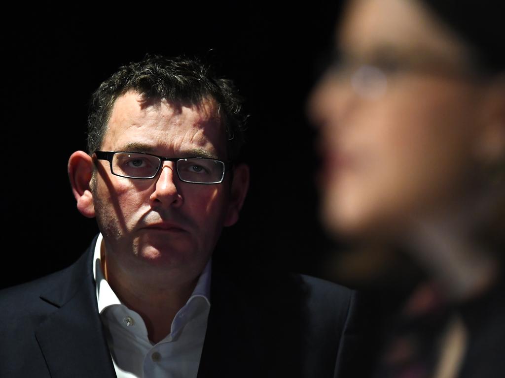 Victorian Premier Daniel Andrews looks on as Victorian Health Minister Jenny Mikakos addresses the media in Melbourne. Picture: James Ross