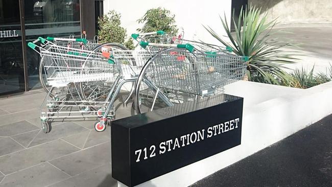 Abandoned trolleys blocking bike racks.