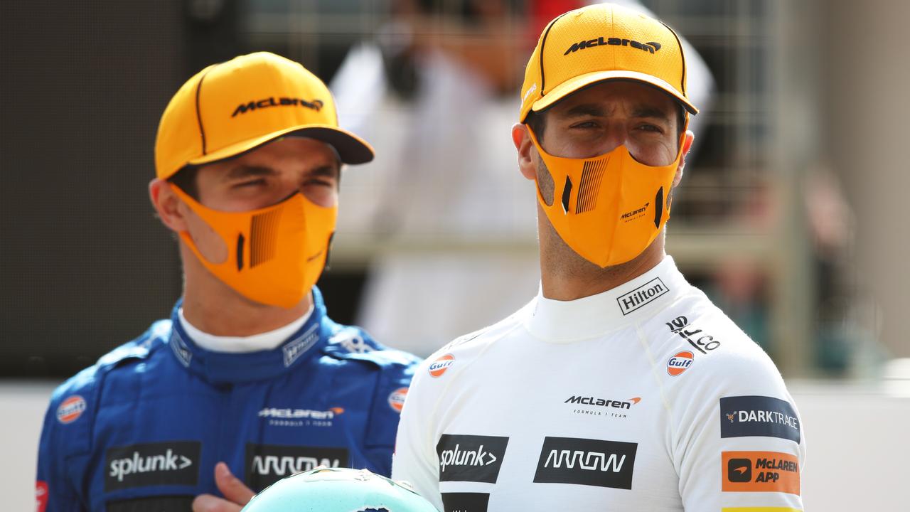BAHRAIN, BAHRAIN - MARCH 12: Lando Norris of Great Britain and McLaren F1 and Daniel Ricciardo of Australia and McLaren F1 stand on the grid during Day One of F1 Testing at Bahrain International Circuit on March 12, 2021 in Bahrain, Bahrain. (Photo by Joe Portlock/Getty Images)