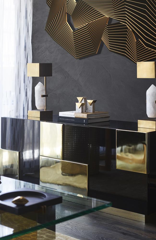 The custom-made sideboard is a play on texture while also reflecting the light.