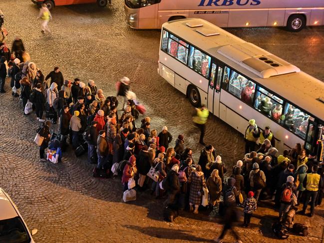 Refugees from Ukraine queue to get on buses to other destinations in Poland, outside the train station in Przemysl, near the Ukrainian-Polish border. Picture: AFP