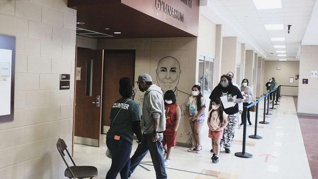 Detroit residents wait in a line outside a pop-up clinic at Western International High School in Detroit, Michigan. Picture: Getty Images