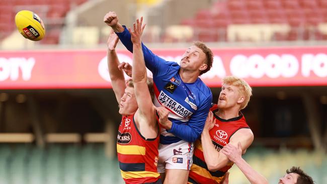 Mature-age Central District prospect Rhett Montgomerie spoils the ball away from Crows Fischer McAsey and Elliot Himmelberg. Picture: James Elsby