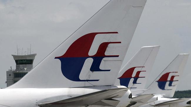 (FILES)-- A file photo taken on October 19, 2003 shows Malaysian Airlines planes parked at the tarmac of Kuala Lumpur International Airport (KLIA). Malaysia Airlines said on July 17, 2014 that it had "lost contact" with one of its passenger planes whose last known position was over Ukraine. "Malaysia Airlines has lost contact of MH17 from Amsterdam," the airline, still reeling from the disappearance of flight MH370, said on its Twitter account. AFP PHOTO/ROSLAN RAHMAN