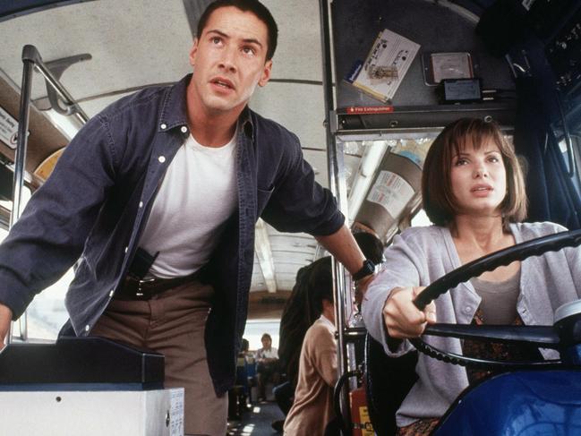 Actor Keanu Reeves with Sandra Bullock in scene from film Speed.