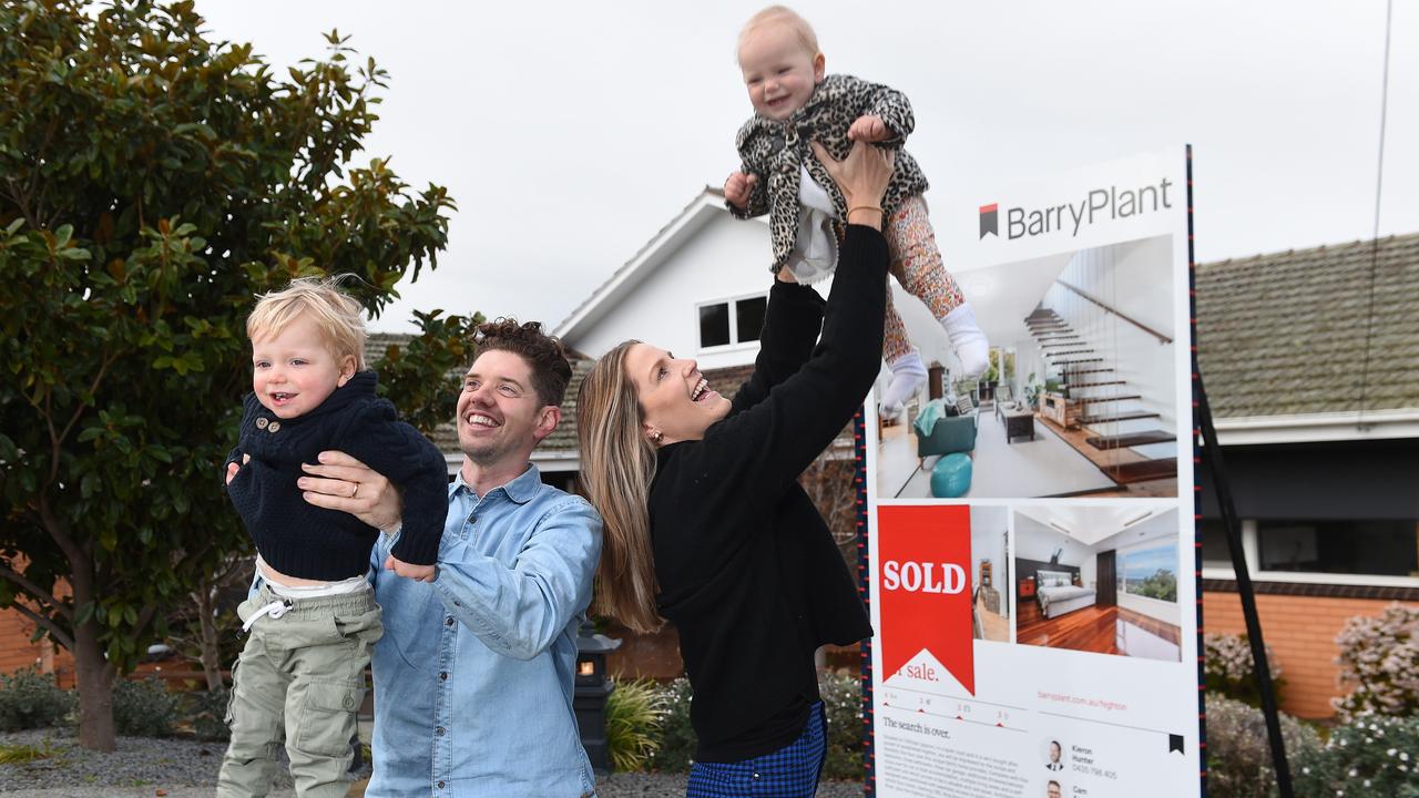 Cal and Jess Forsyth with their children at their new home in Geelong. Picture: Josie Hayden