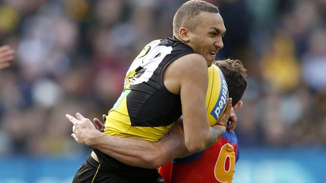 Shai Bolton launches into a tackle from Brisbane’s record-setter Lachie Neale. Picture: Darrian Traynor/Getty Images.