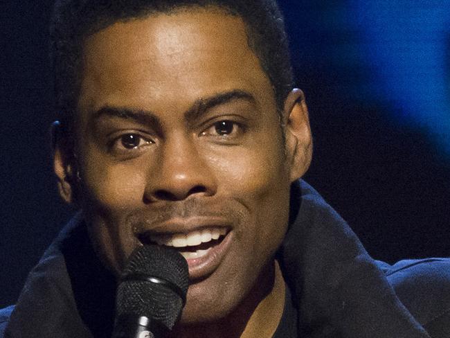 FILE- In this Feb. 28, 2015, file photo, Chris Rock appears onstage at Comedy Central's "Night of Too Many Stars: America Comes Together for Autism Programs" at the Beacon Theatre in New York. Academy Awards producer Reginald Hudlin says host Chris Rock is hard at work rewriting his material for next month’s Oscar show. Hudlin told “Entertainment Tonight” on Saturday, Jan. 23, 2016, that Rock is eager to host the 88th Academy Awards on Feb. 28, even as a few black celebrities have decided not to attend the show for its lack of diversity. (Photo by Charles Sykes/Invision/AP, File)