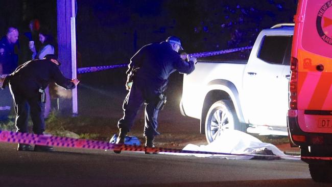 Detectives searching near the body of Comanchero Fares Abounader. Picture : Steve Tyson