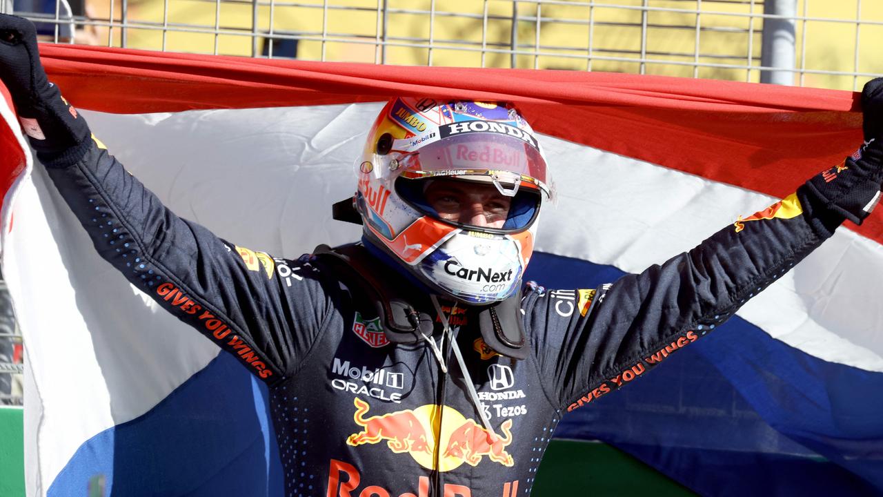 Red Bull's Dutch driver Max Verstappen celebrates in the parc ferme at the Zandvoort circuit after winning the Netherlands' Formula One Grand Prix.