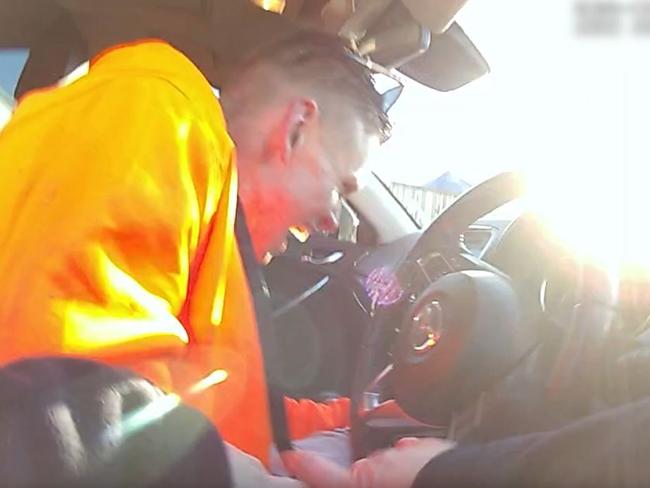 Shocking footage has emerged of the moment a police officer chased down a man who was allegedly attempting to break into a house in rural Queensland. The video shows a man wearing a hi-vis jumper leap from the roof of a property on Farrow Rd in Chambers Flats, before a police officer chases him through the backyard and over the fence. Picture: QLD Police