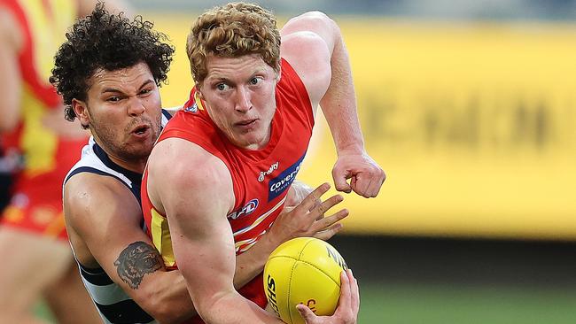 Matt Rowell has of the Suns tackled by Brandon Parfitt of the Cats q1 . Pic: Michael Klein