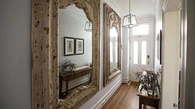 Two enormous framed mirrors from Lawsons Auctioneers create an impressive welcome in the front hallway. Picture: Adam Yip