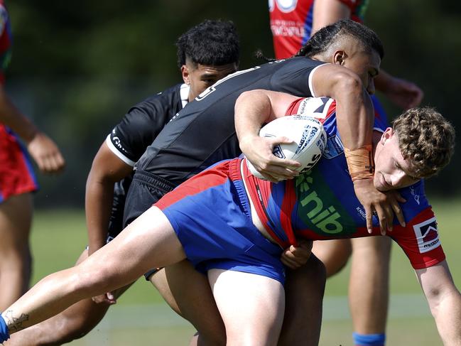 Fletcher Hunt is tackled hard. Picture: Michael Gorton