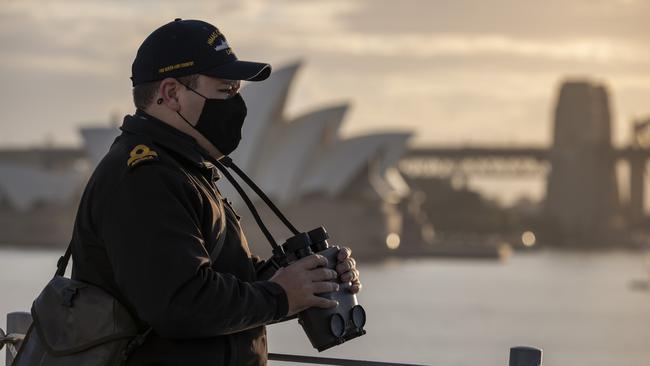 Sub Lieutenant Jaycob Humphreys looks out from the quarterdeck of HMAS Canberra as it departs Fleet Base East in Sydney. It will meet USS Canberra in July. Picture: Defence