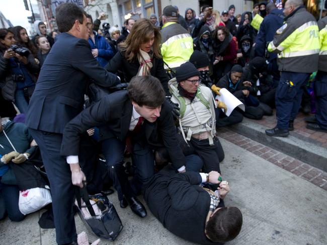 Inaugural attendees move through demonstrators attempting to block people entering a security checkpoint. Picture: AP