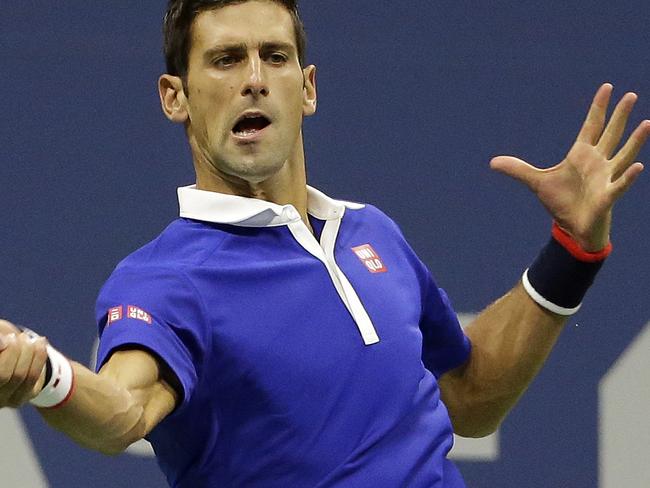 Novak Djokovic, of Serbia, returns a shot to Roger Federer, of Switzerland, during the men's championship match of the U.S. Open tennis tournament, Sunday, Sept. 13, 2015, in New York. (AP Photo/David Goldman)