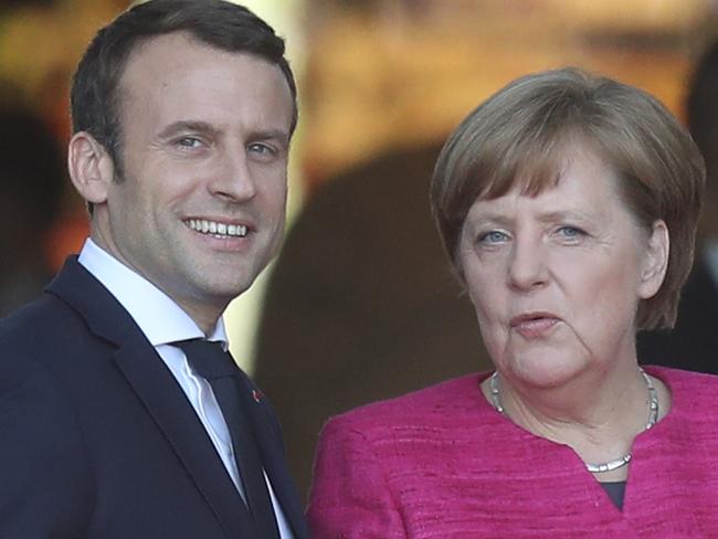 BERLIN, GERMANY - MAY 15:  Newly-elected French President Emmanuel Macron and German Chancellor Angela Merkel chat upon Macron's arrival at the Chancellery on May 15, 2017 in Berlin, Germany. Macron is visiting Berlin only a day after being sworn in as president in Paris. While Macron and Merkel have both demonstrated an unwavering commitment to the European Union and Merkel strongly applauded Macron's election, they are likely to differ over Macron's desire for E.U.-issued bonds, a measure Merkel has strongly opposed in the past.  (Photo by Sean Gallup/Getty Images)