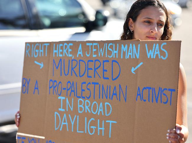 A demonstrator at a makeshift memorial for Paul Kessler. Picture: Getty Images/AFP