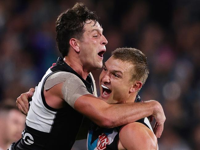 Wines celebrates a goal with Zak Butters. Picture: Sarah Reed/AFL Photos via Getty Images