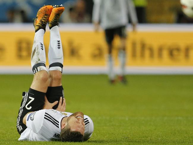 Germany's Shkodran Mustafi holds his leg after suffering an injury during the 2018 World Cup qualifying Group C soccer match between Germany and Azerbaijan in Kaiserslautern, Germany, Sunday, Oct. 8, 2017.(AP Photo/Michael Probst)