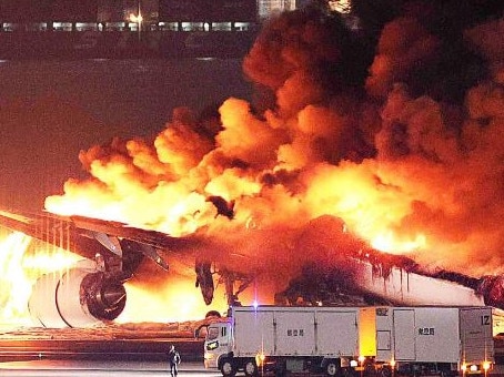A Japan Airlines plane was in flames on the runway of Tokyo's Haneda Airport on January 2 after colliding with a coast guard aircraft. (Photo by JIJI PRESS / AFP)