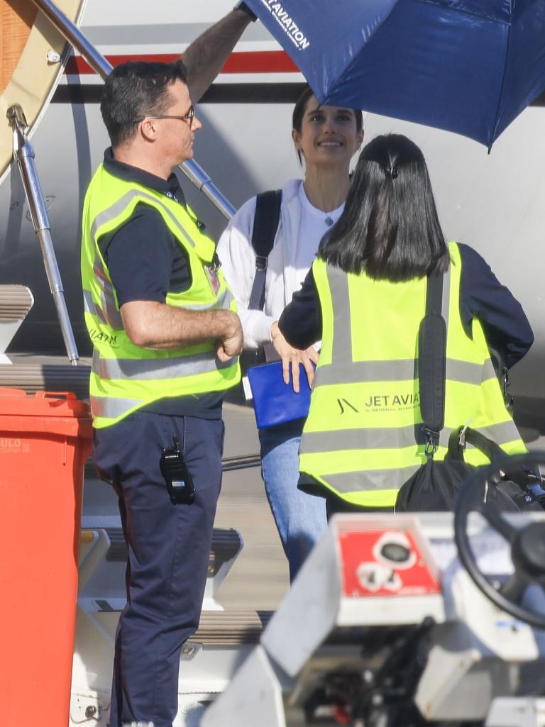 Travolta’s daughter Ella is seen disembarking from their private plane shielded by umbrellas. Picture: MEDIA-MODE.COM