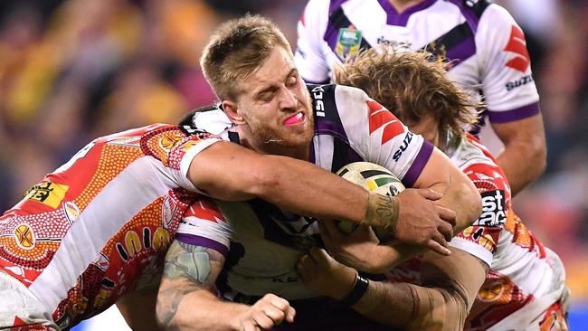 Melbourne’s Cameron Munster is tackled during the match against Brisbane. Picture: Getty Images