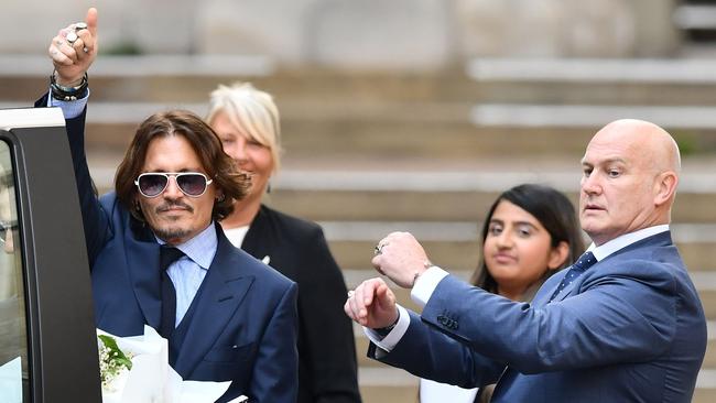 Actor Johnny Depp salutes onlookers as he leaves court in London after the sixth day of his libel trial. Picture: AFP