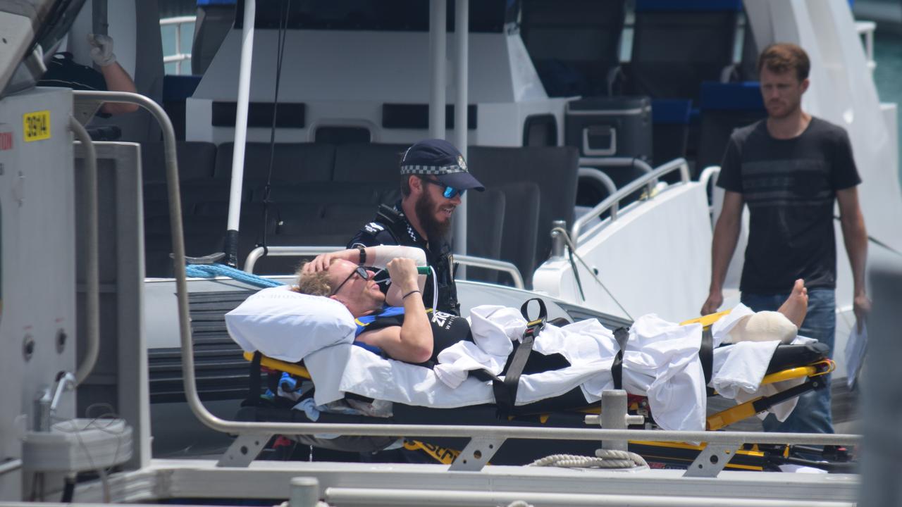 A man is taken to hospital after he was attacked by a shark in the Whitsundays in 2019.