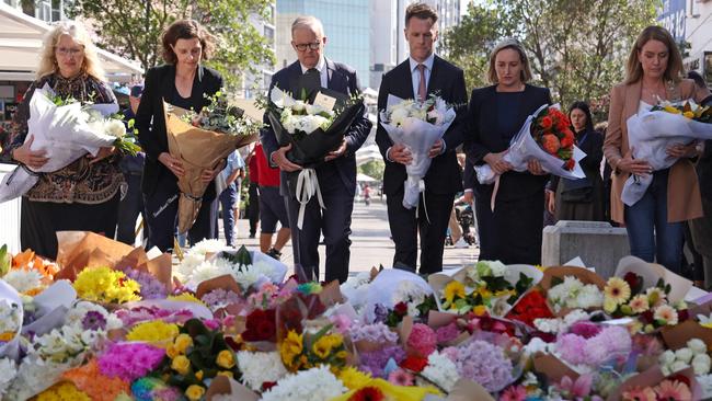 Australian Prime Minister Anthony Albanese stands with New South Wales Premier Chris Minns as they leave flowers outside the Westfield Bondi Junction shopping mall. Picture: DAVID GRAY / AFP