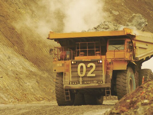 Trucks drive through a Lihir Gold Ltd. mine in Papua New Guinea in this undated handout photograph released to the media on Tuesday, Oct. 30. 2007. Lihir Gold Ltd., a Papua New Guinea- based mining company, had its biggest one-day decline in more than two months in Sydney after cutting 2007 production estimates as a strike at its namesake mine last month disrupted output. Source: Lihir Gold Ltd. via Bloomberg News