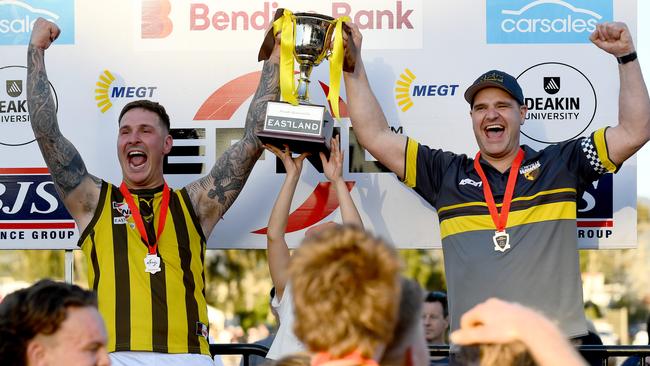 Rowville captain Anthony Brolic and coach Ben Wise hold the cup aloft. Picture: Josh Chadwick