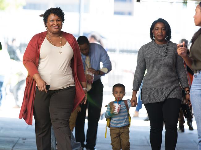 ATLANTA, GA - OCTOBER 28: Democratic Georgia Gubernatorial candidate Stacey Abrams walks into the "Souls to The Polls" march and event in downtown Atlanta on October 28, 2018 in Atlanta, Georgia. Alongside artist Common and Ambassador Andrew Young, Abrams marched with voters to a polling station open for early voting in downtown Atlanta.   Jessica McGowan/Getty Images/AFP == FOR NEWSPAPERS, INTERNET, TELCOS & TELEVISION USE ONLY ==