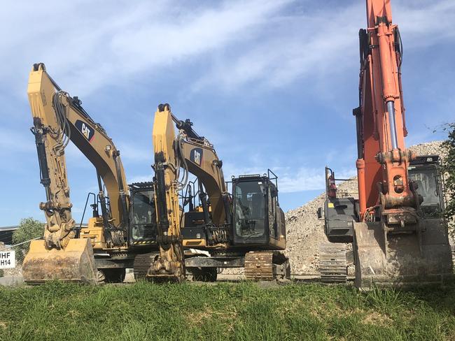 A man has died in a workplace incident involving heavy machinery in Pinkenba.