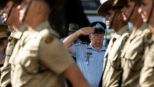 Queensland Police Service Acting Inspector Graeme Paterson salutes as Australian Army soldiers from 3RAR march along Herbert Street. Picture: BDR Guy Sadler