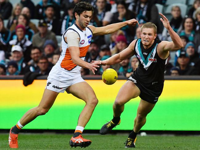 Tim Taranto of the Giants and Tom Clurey of the Power during the Round 18 AFL match between the Port Adelaide Power and the Greater Western Sydney (GWS) Giants at Adelaide Oval in Adelaide, Sunday, July 22, 2018. (AAP Image/David Mariuz) NO ARCHIVING, EDITORIAL USE ONLY