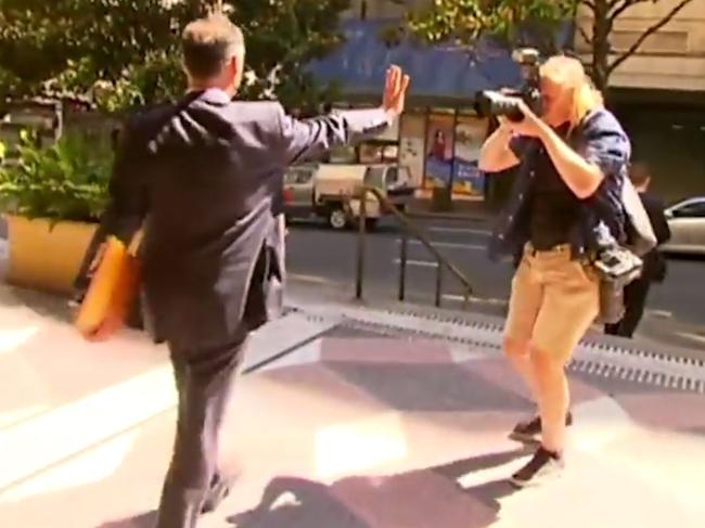 O'Keefe confronts a photographer after leaving Sydney’s Downing Centre Local in March, 2019.